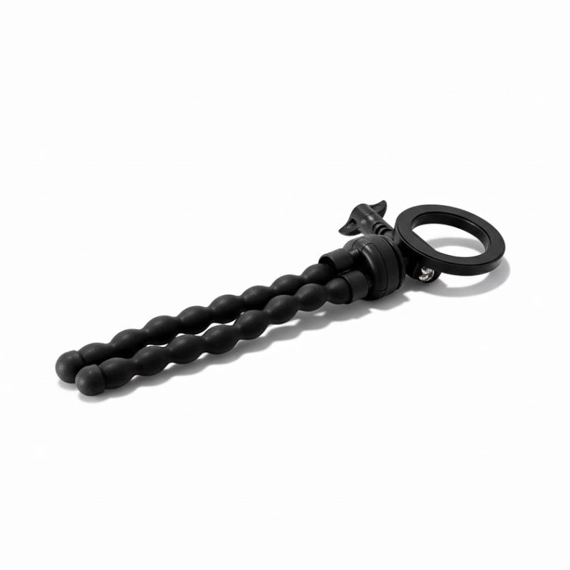 Trépied flexible magnétique plié et poser sur un fond blanc